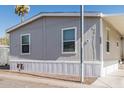 Charming single-story home with gray siding and carport in a sunny community at 2060 N Center St # 133, Mesa, AZ 85201