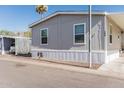 Charming single-story home with gray siding and carport in a sunny community at 2060 N Center St # 133, Mesa, AZ 85201