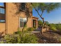 Exterior view of home featuring well-maintained landscaping and a stone accent entrance at 2062 W Roy Rogers Rd, Phoenix, AZ 85085