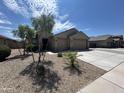 Charming home with a well-maintained front yard, desert landscaping, and a spacious driveway at 22325 N 185Th Ave, Surprise, AZ 85387