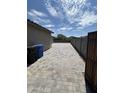 Paver-lined side yard leading to backyard with secure privacy gate at 22325 N 185Th Ave, Surprise, AZ 85387