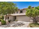 Charming two-story home with desert landscaping, mature trees, and a spacious driveway at 2746 E Fawn Dr, Phoenix, AZ 85042
