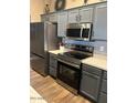 Modern kitchen featuring stainless steel appliances, gray cabinets, and granite countertops at 29954 N Broken Shale Dr, San Tan Valley, AZ 85143