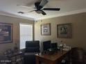 Cozy office space with a ceiling fan, a window for natural light, and a workspace with a computer at 29954 N Broken Shale Dr, San Tan Valley, AZ 85143