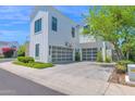 Bright white home with a two-car garage, modern design, and well-kept landscaping at 3718 E Sells Dr, Phoenix, AZ 85018