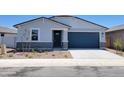 Charming single-story home showcasing a blue garage door and professionally landscaped front yard at 3805 N Camden Dr, Florence, AZ 85132