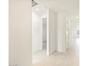 Bright hallway with tile flooring, neutral walls, and recessed lighting leading to various rooms at 3805 N Camden Dr, Florence, AZ 85132