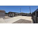 A spacious concrete parking area with a covered carport at 404 E Centre Ave, Buckeye, AZ 85326