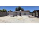 Exterior view showing the home's front door and spacious concrete patio at 404 E Centre Ave, Buckeye, AZ 85326