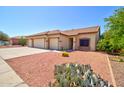 The exterior showcases a low-maintenance desert landscape complementing the home's facade and three-car garage at 639 E Palo Verde St, Casa Grande, AZ 85122