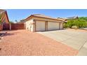 A single-story home features a spacious three-car garage and low-maintenance desert landscaping at 639 E Palo Verde St, Casa Grande, AZ 85122