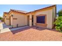 A covered entrance to the house features a desert rock yard and well maintained landscaping at 639 E Palo Verde St, Casa Grande, AZ 85122