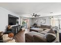 Open-concept living room with a sectional sofa and sliding glass doors to the outdoor space at 671 W Jahns Ct, Casa Grande, AZ 85122