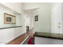 Inviting entryway with a view into the house, marble accents and wood floors at 7324 S Bonarden Ln, Tempe, AZ 85283