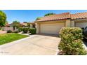 Front exterior highlighting a two-car garage and well-manicured landscaping at 7324 S Bonarden Ln, Tempe, AZ 85283