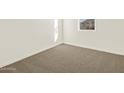 A bedroom with plush carpeting and natural light at 8560 W Yorktown Ct, Florence, AZ 85132