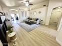 Spacious living area with light wood floors, modern furniture, and stylish decor at 8673 W Palm Ln, Phoenix, AZ 85037