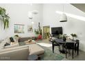 Bright living room with high ceilings, stylish furniture, and large windows providing natural light at 1111 W University Dr # 1017, Tempe, AZ 85281