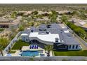 Aerial view of a luxury home with a backyard pool, lush landscaping, and desert views at 13074 E Saddlehorn Trl, Scottsdale, AZ 85259