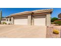 Spacious three-car garage with ample parking and a well-maintained driveway at 20017 N Cielo Ct, Surprise, AZ 85374
