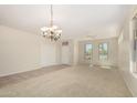 Bright living room featuring carpet flooring, large windows, and a ceiling fan at 20017 N Cielo Ct, Surprise, AZ 85374
