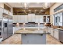 Modern kitchen with custom cabinets, stainless steel appliances, and a granite countertop island at 42001 N Bridlewood Way, Phoenix, AZ 85086