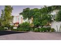 An exterior shot of a home displaying unique architectural details and mature greenery at 4316 N 40Th St, Phoenix, AZ 85018