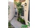 Charming walkway to the front door framed by plants and neutral walls at 6223 N 12Th St # 1, Phoenix, AZ 85014
