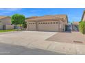 Charming single-story home with a tile roof, lush lawn, gated entry, and a two-car garage at 8354 W Marlette Ave, Glendale, AZ 85305