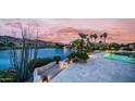 Stunning backyard oasis with a pool, a lake view, and steps to a patio at 16239 S 18Th Pl, Phoenix, AZ 85048