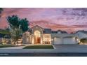 Inviting home with an arched entryway, manicured lawn, and a fountain at 16239 S 18Th Pl, Phoenix, AZ 85048