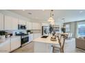 Contemporary kitchen featuring white cabinets, stainless steel appliances, and a center island at 16743 W Charlotte Dr, Surprise, AZ 85387