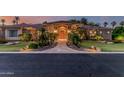 Inviting front entrance with a stone walkway, lush landscaping, and a beautiful custom wood door at 1758 E Carver Rd, Tempe, AZ 85284