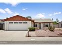 Charming single-story home with desert landscaping, a two-car garage and mature cacti at 2745 E Dahlia Dr, Phoenix, AZ 85032