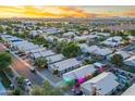 Panoramic aerial view showcasing a vibrant neighborhood with homes, pools, and colorful lighting at 3550 E Edna Ave, Phoenix, AZ 85032