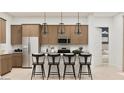 Bright kitchen with a center island, bar stool seating, and stainless steel appliances at 3703 E Gold Mountain Ave, San Tan Valley, AZ 85143