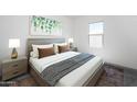 Comfortable bedroom with neutral tones, large window, and stylish bedside tables at 10318 S 58Th Ln, Laveen, AZ 85339