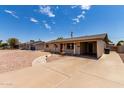 Charming single-story home featuring gravel landscaping, a carport, and concrete driveway at 1545 W 7Th Ave, Mesa, AZ 85202