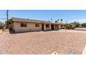 View of a single-story home with gravel landscaping, a charming fountain, and a covered carport at 1545 W 7Th Ave, Mesa, AZ 85202