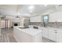 Bright, remodeled kitchen featuring white cabinets, stainless steel appliances, and large island with modern countertops at 2107 W Lane Ave, Phoenix, AZ 85021
