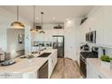 A modern kitchen with stainless steel appliances, a center island, and ample cabinet space for storage and organization at 2955 E Lucky Horseshoe Ln, San Tan Valley, AZ 85140