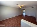 Open living room with tile floors and a ceiling fan, offering a bright and airy space at 324 E Riviera Dr, Tempe, AZ 85282