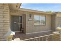 Inviting front entrance featuring a beige brick facade, security door, and well-lit address number at 4117 E Carol Ave, Mesa, AZ 85206