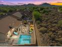 Aerial view of backyard featuring a pool, outdoor kitchen, and patio in a private setting at 6106 W Spur Dr, Phoenix, AZ 85083