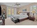 Bright bedroom with king bed, modern furnishings, carpet floors, and backyard pool access at 6106 W Spur Dr, Phoenix, AZ 85083