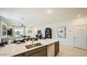 Bright kitchen with island, stainless steel sink and appliances, and open layout to the living area at 9538 W Avalon Dr, Phoenix, AZ 85037