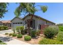 Charming single-story home featuring a two car garage and desert landscaping in the front yard at 9642 E Tesla Ave, Mesa, AZ 85212