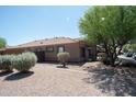 A side view of a single-story home with desert landscaping and neutral earth tone colors at 1381 E Prickly Pear Dr, Casa Grande, AZ 85122