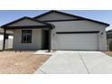 New construction single-story home with a two-car garage and concrete driveway at 24105 W Bowker St, Buckeye, AZ 85326