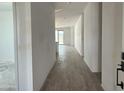 Entryway and hallway featuring wood-look tile flooring and white walls at 24105 W Bowker St, Buckeye, AZ 85326
